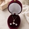 925 sterling silver butterfly pendant and earrings set with mother of pearl and cubic zirconia in rose gold plating.